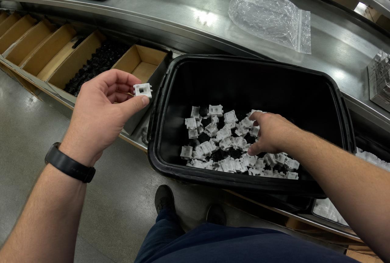 Egocentric view of a worker picking components from a bin into a tote